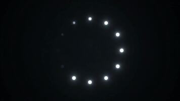 Dynamic loading animation with pulsing light points against black backdrop for technology startup or software company promotional clips video