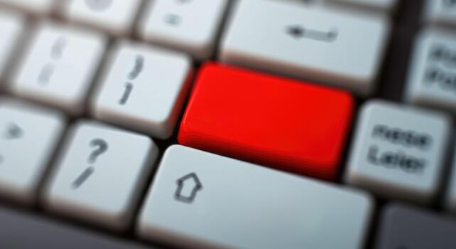 Close-up of keyboard with red Enter key, emphasizing importance or urgency photo
