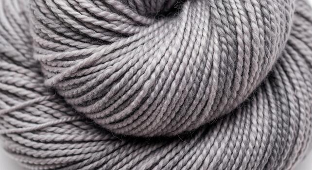 Close up of a variegated grey and pink yarn skein showing its soft texture and subtle color transitions photo