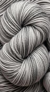 Close up of a skein of variegated yarn with a marbled pattern of grey and white fibers creating a textured effect photo