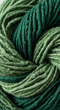 Close up view of a skein of variegated green yarn with a textured slightly fuzzy appearance and subtle speckles photo
