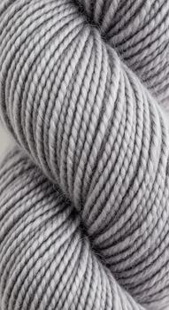 Close up macro shot of a skein of variegated grey yarn highlighting its soft texture and subtle color variations perfect for knitting or crochet projects photo