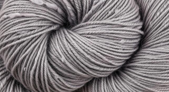 Close up macro view of a variegated yarn skein with subtle pink and grey tones creating a unique textured pattern photo