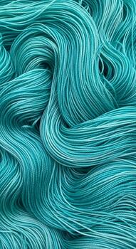 Close up abstract view of flowing strands of variegated teal yarn creating a textured and organic pattern photo
