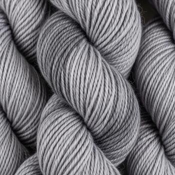 Close up view of soft variegated grey and lavender yarn skeins creating a textured cozy background for crafting projects photo