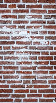 A close up view of a weathered red brick wall with visible mortar lines and subtle texture variations photo