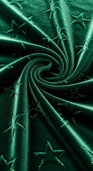 Abstract swirling vortex of metallic green fabric with embossed star pattern creating a dynamic and textured visual effect photo