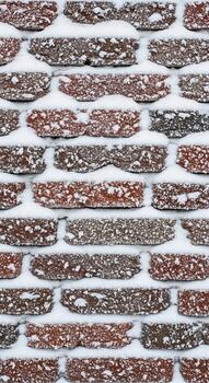 Close up view of a weathered brick wall with varied textures and colors creating a rustic and aged architectural background photo