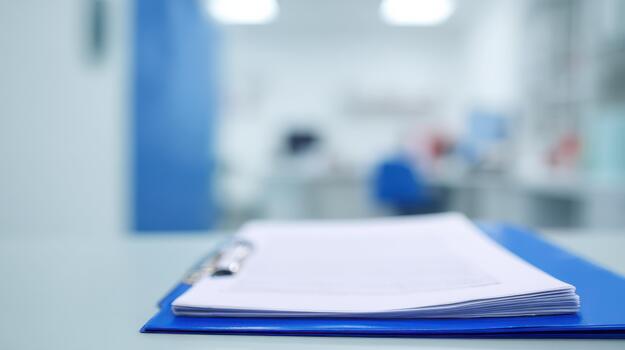 Stack Of Documents On Blue Clipboard In Office Setting. Organized Paperwork In Professional Environment photo