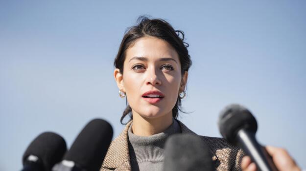 Woman Speaking At Press Conference With Microphones. Public Address And Media Interaction photo