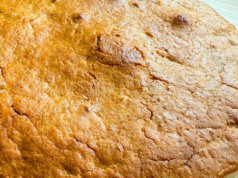 Golden crust with cracks and texture from baking. Warmth, comfort, and homemade simplicity reflecting cozy domestic moments and natural imperfection photo