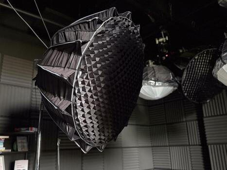 Studio softbox light with grid diffuser in professional setup. Photography equipment, lighting control and creative workspace for visual production and content creation. photo