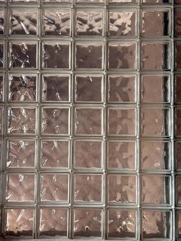 Pattern of glass blocks with reflective surface and textured transparency. Architectural design, geometric repetition and light abstraction in modern interior. photo