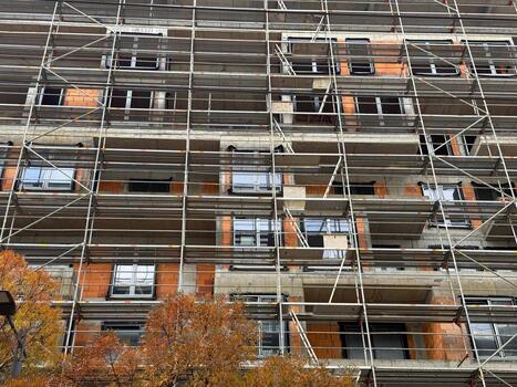 Scaffolding pattern on facade of an urban construction site. Engineering precision, geometry and transformation in architectural development. photo