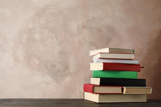 Stack of books against brown, space for text Stack of books against brown, space for text photo