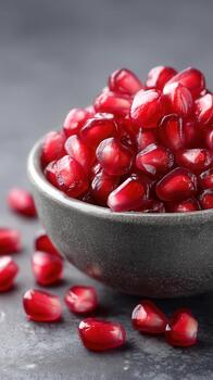 Fresh pomegranate seeds in bowl create vibrant display of health and food. Their juicy texture and rich color make them delightful addition to any dish photo