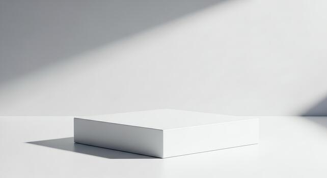 A minimalist white rectangular pedestal bathed in dramatic light and shadow, creating a liminal space for product display photo