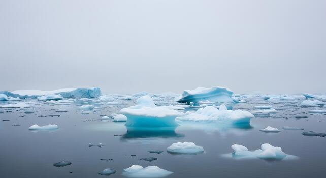 Arctic Ice Formations Stunning Collection of Icebergs Floating in a Calm, Misty Ocean on a Cloudy Day photo