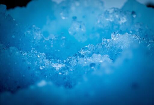 Detailed view of the layered structure and sharp broken edges within the vibrant blue ice mass photo