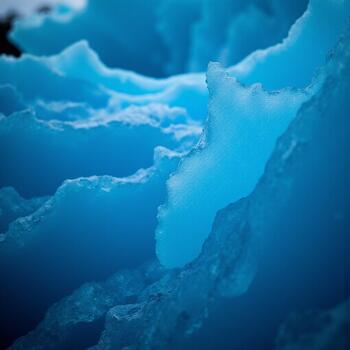 Detailed view of the layered structure and sharp edges within the vibrant blue ice formation photo