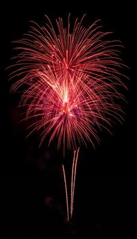 Close-up on the intricate patterns of the expanding firework shells creating luminous spheres photo