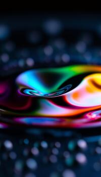 A majestic display of fluid dynamics with the central droplet creating a perfect colorful form photo