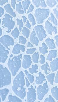 Macro view of a shattered blue ice surface showing intricate crack patterns and crystalline shards photo