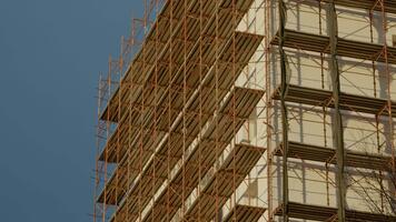 arbetare är förstärkning termisk effektivitet förbi isolerande en flervånings lägenhet byggnad. de projekt är del av ett pågående rehabilitering och renovering ansträngning. video