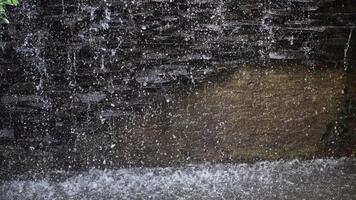 Serene Waterfall Splashing on Natural Stone Wall Creating Calming Atmosphere in Lush Garden Setting with Gentle Flow and Vivid Nature Surroundings video