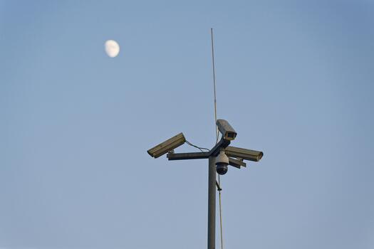 Tall pole with multiple surveillance cameras facing all sides photo