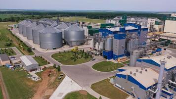 Present day granary plant with newly built premises and ones under construction. Abundant industrial zone in the fields. Nature background. video