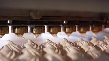 Automated line with rotating nozzles producing vanilla marshmallows. Close up. Food factory concept. video