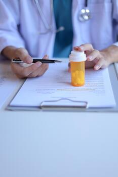 Doctor or General practitioner explain to patient how to use prescribed medicine correctly by explain dosage, frequency, and timing. photo