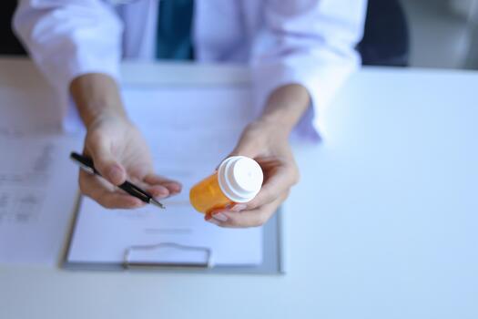General practitioner explain to patient how to use prescribed medicine correctly by explain dosage, frequency, and timing. photo