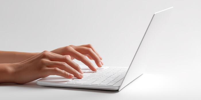 Person typing on white laptop keyboard technology photo