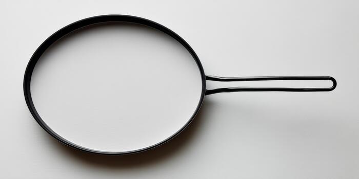 Empty frying pan creating minimalist white space background photo