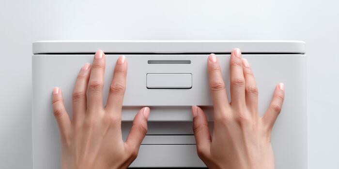 Hands opening top drawer of office filing cabinet photo