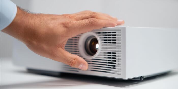 Hand adjusting digital projector lens during business presentation photo