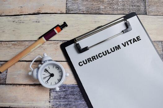 Concept of curriculum vitae write on clipboard isolated on Wooden Table. photo