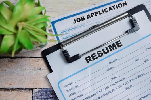 Concept of job application and resume write on clipboard isolated on Wooden Table. photo