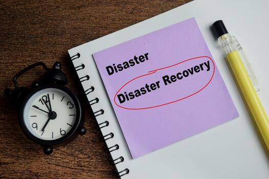 Concept of disaster recovery write on sticky notes isolated on Wooden Table. photo