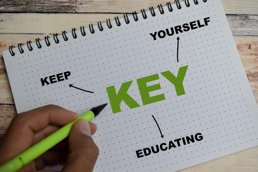 Concept of mind map KEY - Keep Educating Yourself write on book with keywords isolated on Wooden Table. photo