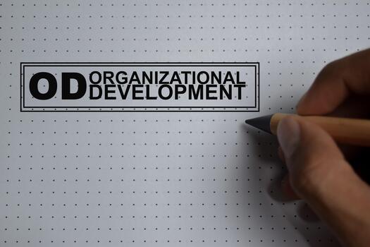 Concept of OD - Organizational Development write on book isolated on Wooden Table. Is the study and implementation of practices, systems, and technique photo