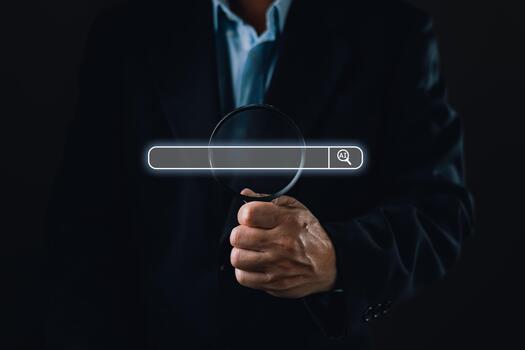 businessman hold a magnifying glass aligned with a glowing digital search bar featuring an AI icon, representing concepts of ai, searching, seo optimization, and magnifying precision in technology. photo