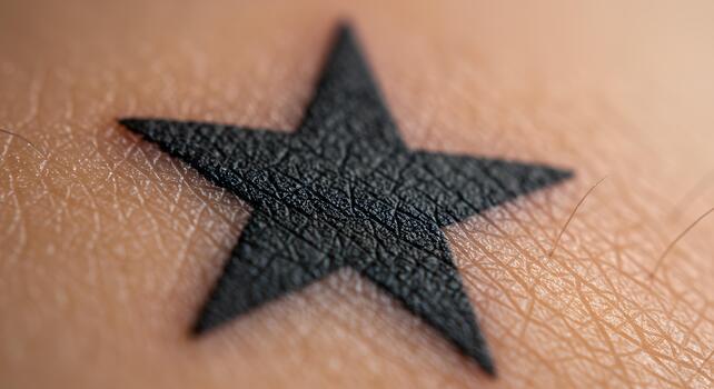 High-quality macro close-up image of a star tattoo on human skin, captured in sharp detail under soft studio lighting photo