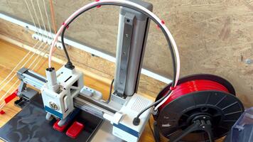 3d printer creating red plastic object video