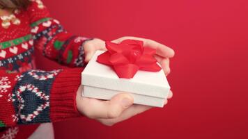 Slow motion closeup of a girl opening a small gift box with empty background space suitable for text or design placement video