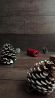 Vertical slow motion macro clip showing rustic holiday decor on wooden table as camera slides right creating warm seasonal copy space video