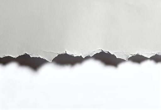Torn paper edge revealing a contrasting background. photo