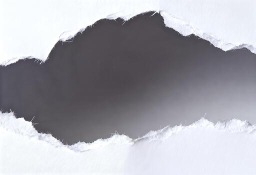 Torn white paper with dark background showing through the rip. photo